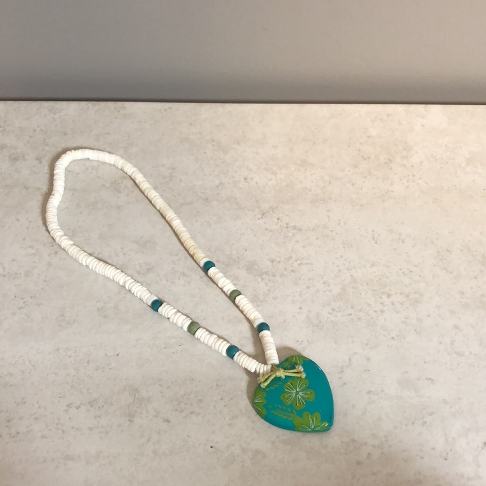 9.5” Hawaiian puka shell necklace with floral heart